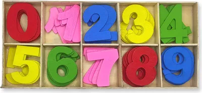 A wooden tray with compartments filled with colorful foam numbers.