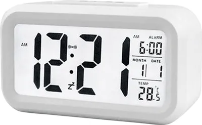 A digital alarm clock displaying the time, date, and temperature.
