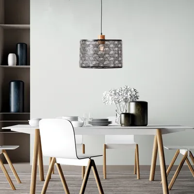 A dining room setting with a table, chairs, and a pendant light.