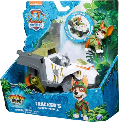 The image shows the retail packaging of a Spin Master PAW Patrol Jungle Pups Vehicles Tracker toy. The packaging features jungle-themed graphics and displays the toy vehicle and a figure of the character Tracker.