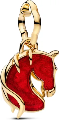 A close-up studio shot of a gold and red horse charm.