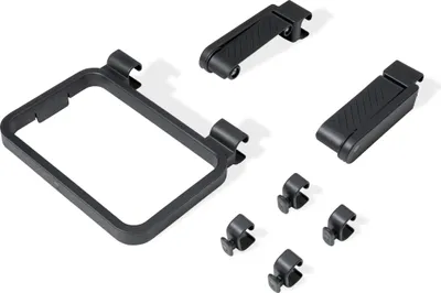 A set of black plastic accessories for a grill, including a trash bag holder, a paper towel holder, and four utensil hooks.