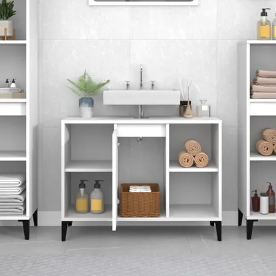 A white bathroom vanity with a sink and various bathroom accessories.