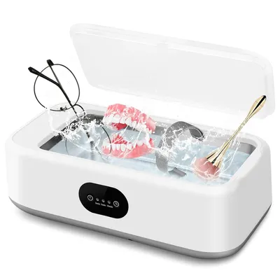 A white ultrasonic cleaning device with a clear lid, containing water and various items being cleaned.