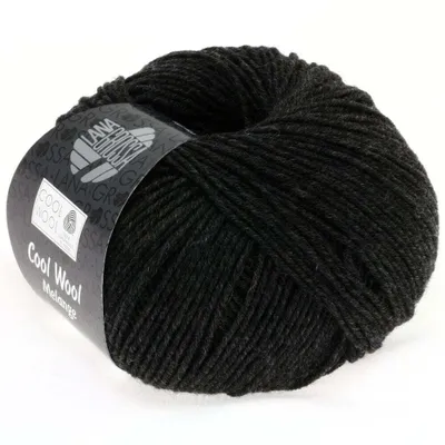 A ball of black yarn with a label wrapped around it.