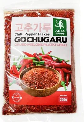 A bag of Gochugaru chili pepper flakes with a picture of chili peppers and a bowl of the product.