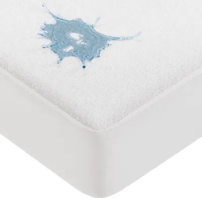 A close-up of a white mattress protector with a blue liquid spill on it.