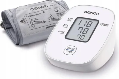 A white Omron blood pressure monitor and its gray cuff are shown on a white background.