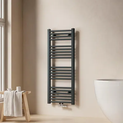 A modern bathroom setting with a towel radiator, a wooden stool with a towel, and a bathtub.