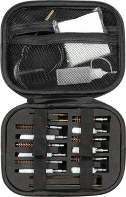 An open cleaning kit for a pistol, showing various tools and brushes organized within a black case.