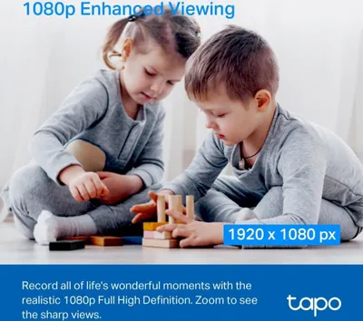 Two children playing with wooden blocks on the floor.