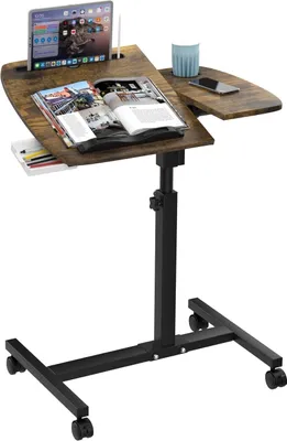 A mobile, height-adjustable laptop table with wheels, shown with a tablet, a magazine, and a cup.