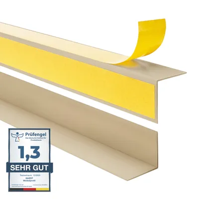 A close-up, angled view of two beige corner profiles, one with yellow adhesive tape being peeled back.