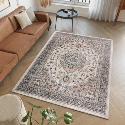 A living room scene with a brown leather sofa and a patterned rug.