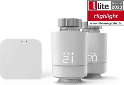 Two smart thermostats and a central hub are displayed against a white background.