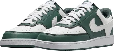 A pair of Nike Court Vision Lo sneakers in vintage green and white.