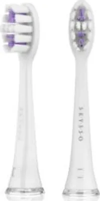 Two white toothbrush heads with purple bristles are shown against a white background.