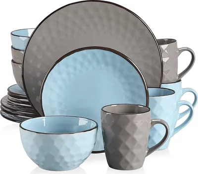 A collection of ceramic plates, bowls, and mugs with a textured pattern.