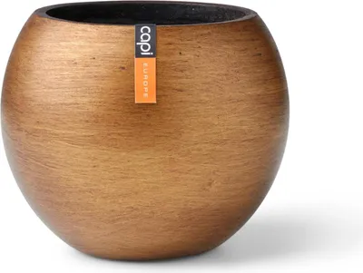 A round, golden-brown planter pot with a textured finish, shown against a white background. A small orange tag with black text is attached to the side of the pot.