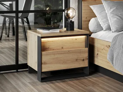 A modern bedroom setting with a nightstand next to a bed.