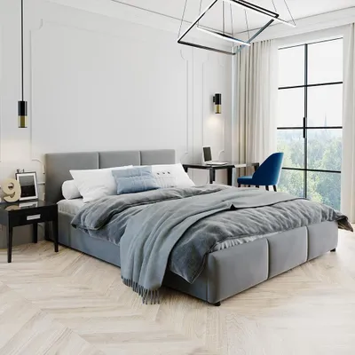 A modern bedroom with a bed, desk, and chair.