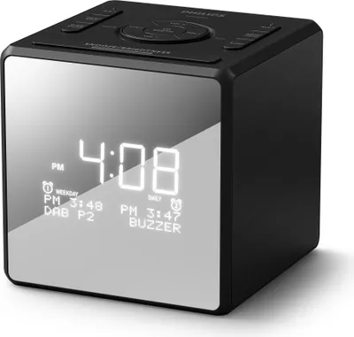 A black cube-shaped digital alarm clock with a reflective screen displaying the time and alarm settings.