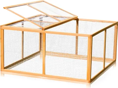 A wooden outdoor enclosure with a mesh roof, shown from a slightly elevated side angle.