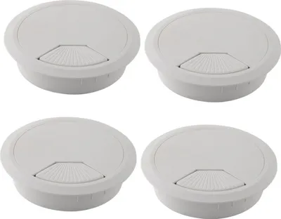 Four white desk cable grommets arranged in a 2x2 grid.
