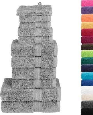 A stack of gray towels of varying sizes, arranged in a pyramid shape, with a row of colorful towels on the right side of the image.