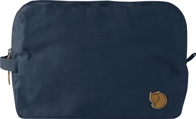 A navy blue toiletry bag with a brown logo.