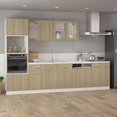 A modern kitchen with light wood cabinets and white countertops.