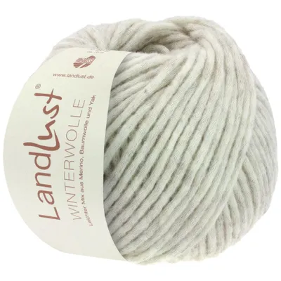 A ball of beige and light brown speckled yarn with a label attached.