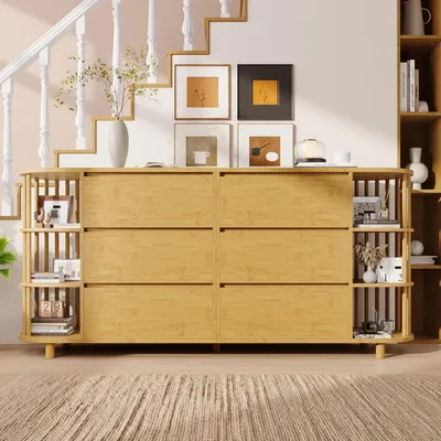 A wooden dresser with shelves is placed in a room with a staircase and framed pictures on the wall.