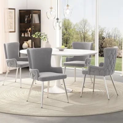 A dining room setting with a round table and four chairs.