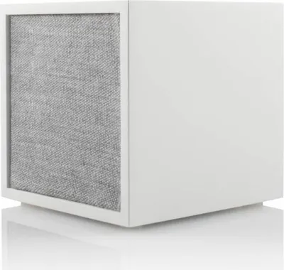 A white cube-shaped speaker with a gray fabric front, shown in a studio setting with a white background and reflection.