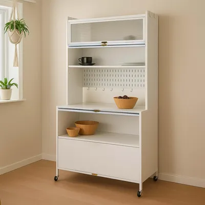 A white kitchen cabinet with glass doors and wooden bowls on shelves, placed in a room with light walls and wooden flooring.