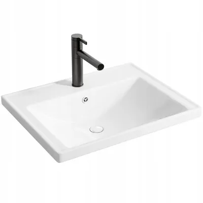 A white ceramic sink with a black faucet.