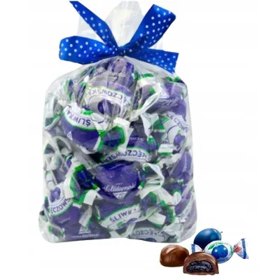 A bag of individually wrapped plum candies, with a few candies shown outside the bag.