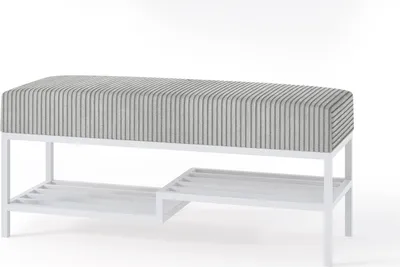 A white metal frame bench with a gray and white striped upholstered seat and two shelves underneath.