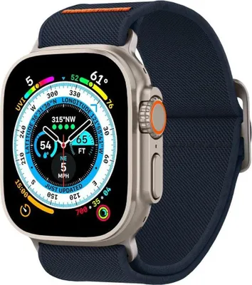 A close-up shot of an Apple Watch Ultra with a navy blue band, displaying a detailed watch face with various metrics.