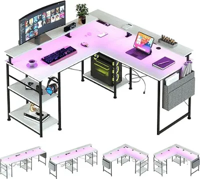 An L-shaped desk with a computer, monitor, keyboard, and LED lighting.