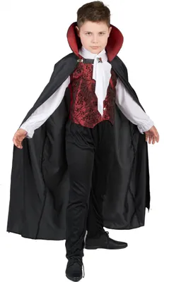 A young boy dressed in a vampire costume.