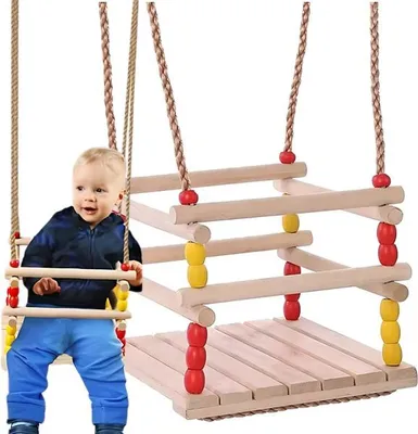 A baby sitting on a wooden swing.