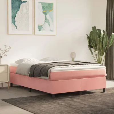 A pink bed frame with a mattress and bedding in a bedroom setting.