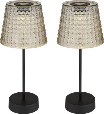 Two solar-powered table lamps with textured glass shades and black bases.