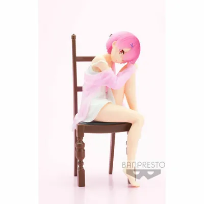 A figurine of a character sitting on a chair against a pink and white background.