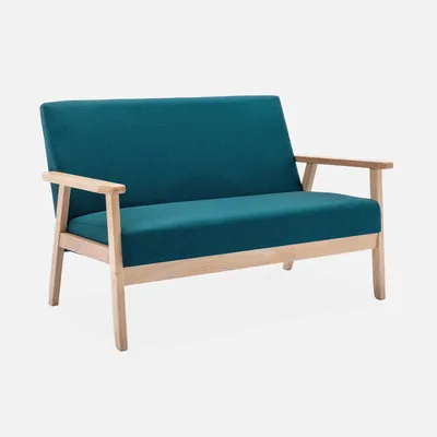 A teal upholstered loveseat with light wood legs and armrests, shown from a side-angle against a light gray background.