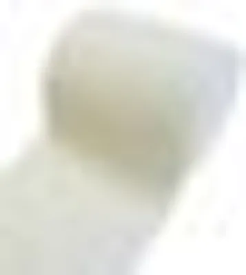 A close-up, blurry view of a roll of fabric.