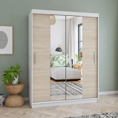 A wardrobe with mirrored doors in a room setting, reflecting a sofa and decor.