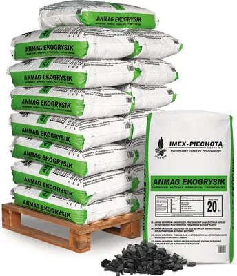A stack of bags of coal on a pallet, with a single bag and some loose coal in the foreground.